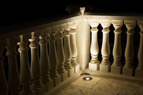 AMP® Well Lights illuminating a patio