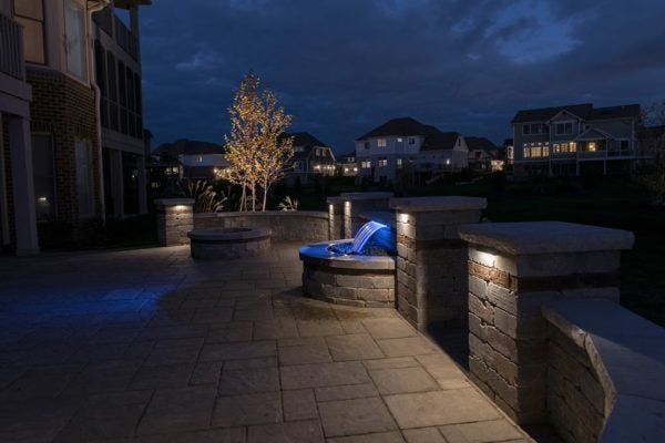 Illuminated paver patio with AMP® Hardscape Lights