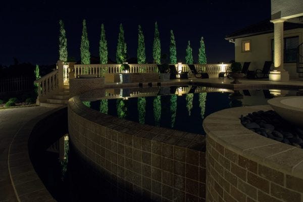 Illuminated pool patio with AMP® Well Lights & Spotlights