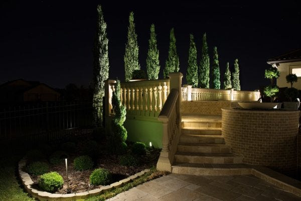 AMP® Well Lights illuminating a patio