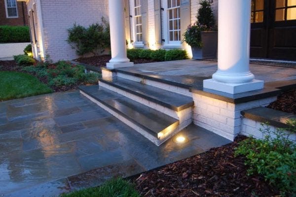 Illuminated home with AMP® Well Lights & Spotlights