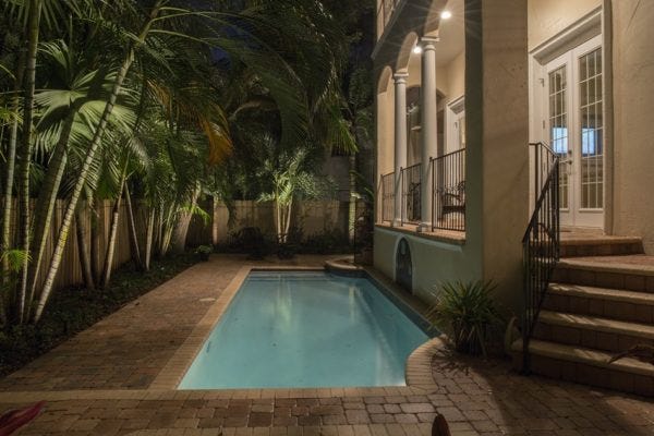 Illuminated backyard pool patio using AMP® Spot Lights