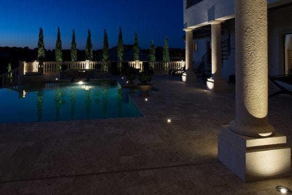 Illuminated pool patio with AMP® Well Lights & Spotlights