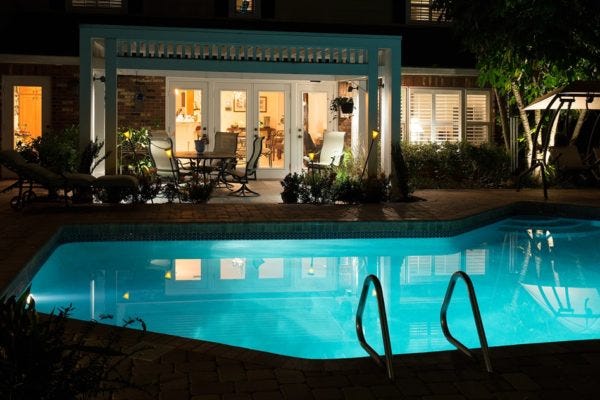 Illuminated pool patio with AMP® Spotlights