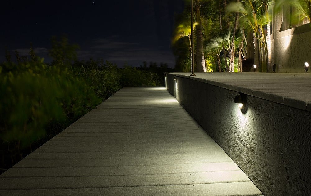 AMP® Deck Lights illuminate a backyard deck