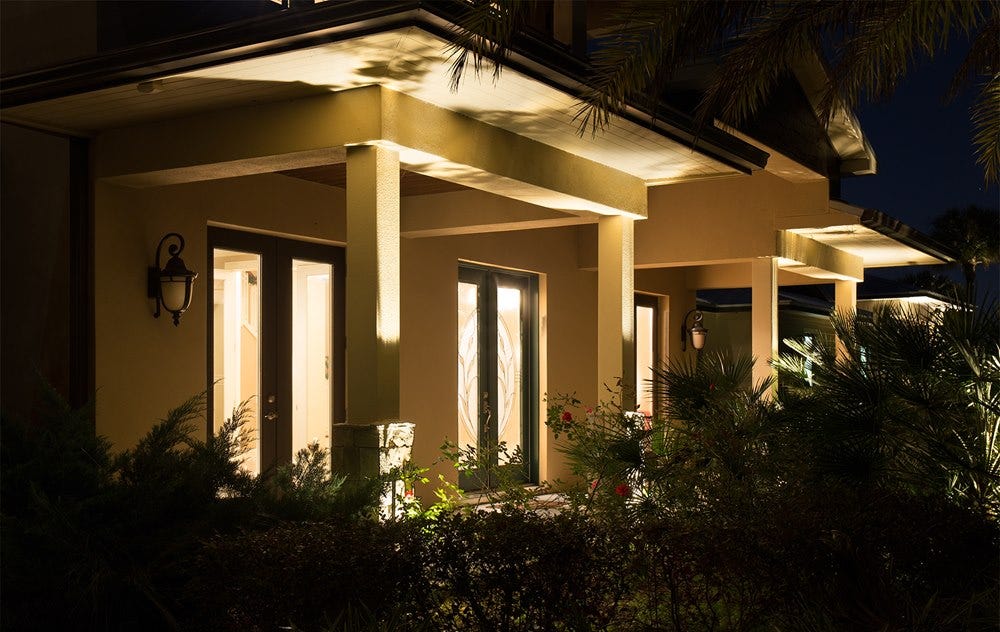 AMP® Spotlights illuminate the front of a home