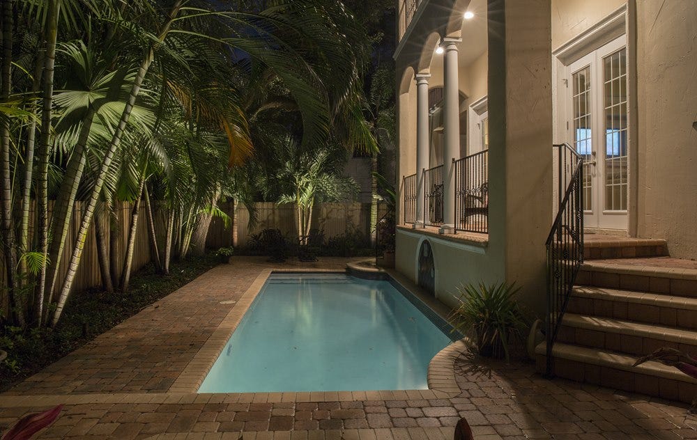 Illuminated backyard pool patio using AMP® Spot Lights